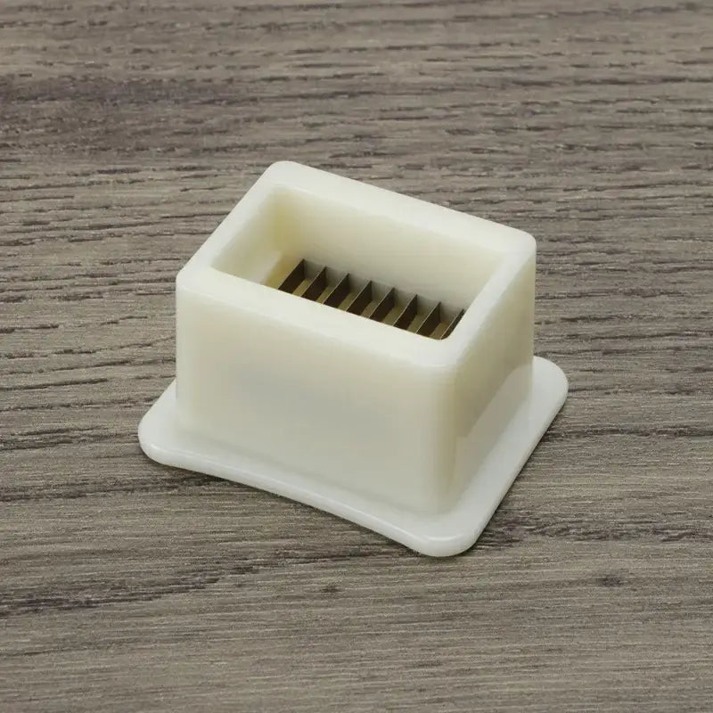 White plastic green bean slicer with metal blades kitchen shredder