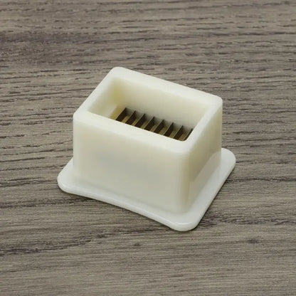 White plastic green bean slicer with metal blades kitchen shredder