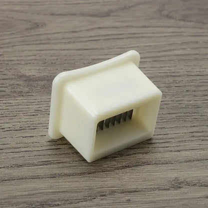 White plastic green bean slicer with metal blades kitchen shredder