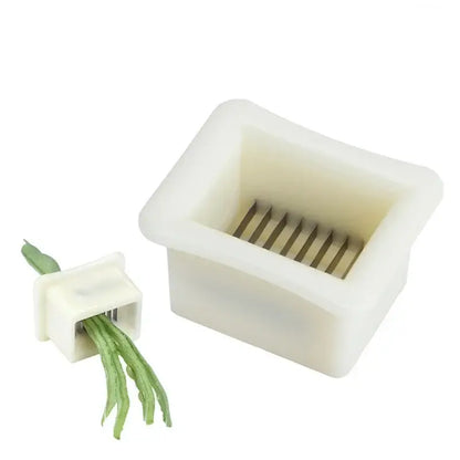 White plastic green bean slicer with metal blades kitchen shredder
