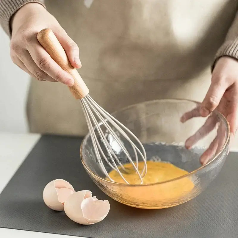 White silicone kitchen cookware set with wooden handles and holder