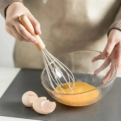 White silicone kitchen cookware set with wooden handles and holder