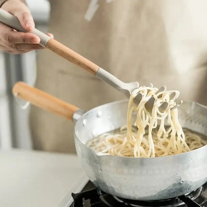 White silicone kitchen cookware set with wooden handles and holder